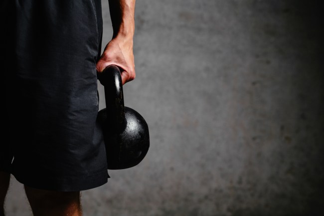 Photo of an athlete arm holding a kettlebell