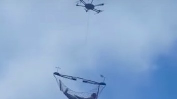 Dude Flying Around In A Hammock Being Carried By A Drone Is DEFINITELY Living His Best Life