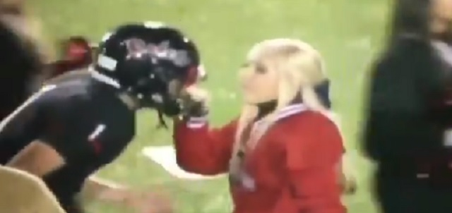 Cheerleader Grabs Her QB Boyfriend By The Face Mas