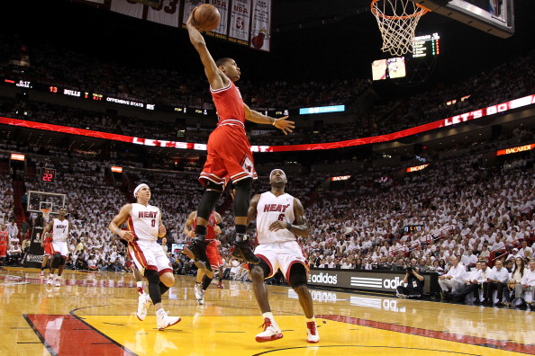 Derrick Rose #1 of the Chicago Bulls dunks against LeBron James