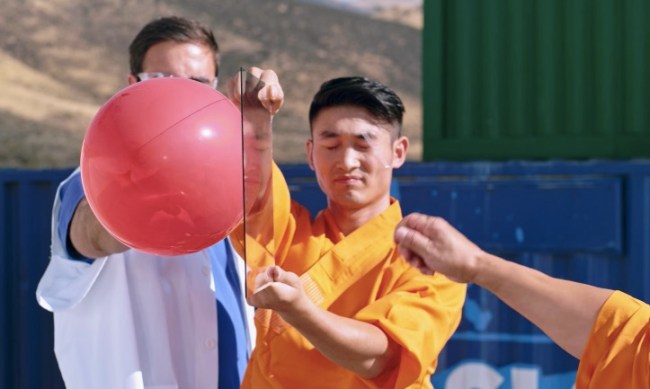 shaolin monks throw needle through glass