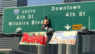 Vaping Man Climbs Freeway Sign In L.A. Before Backflipping To The Ground, Shutting Down Highway During Rush Hour