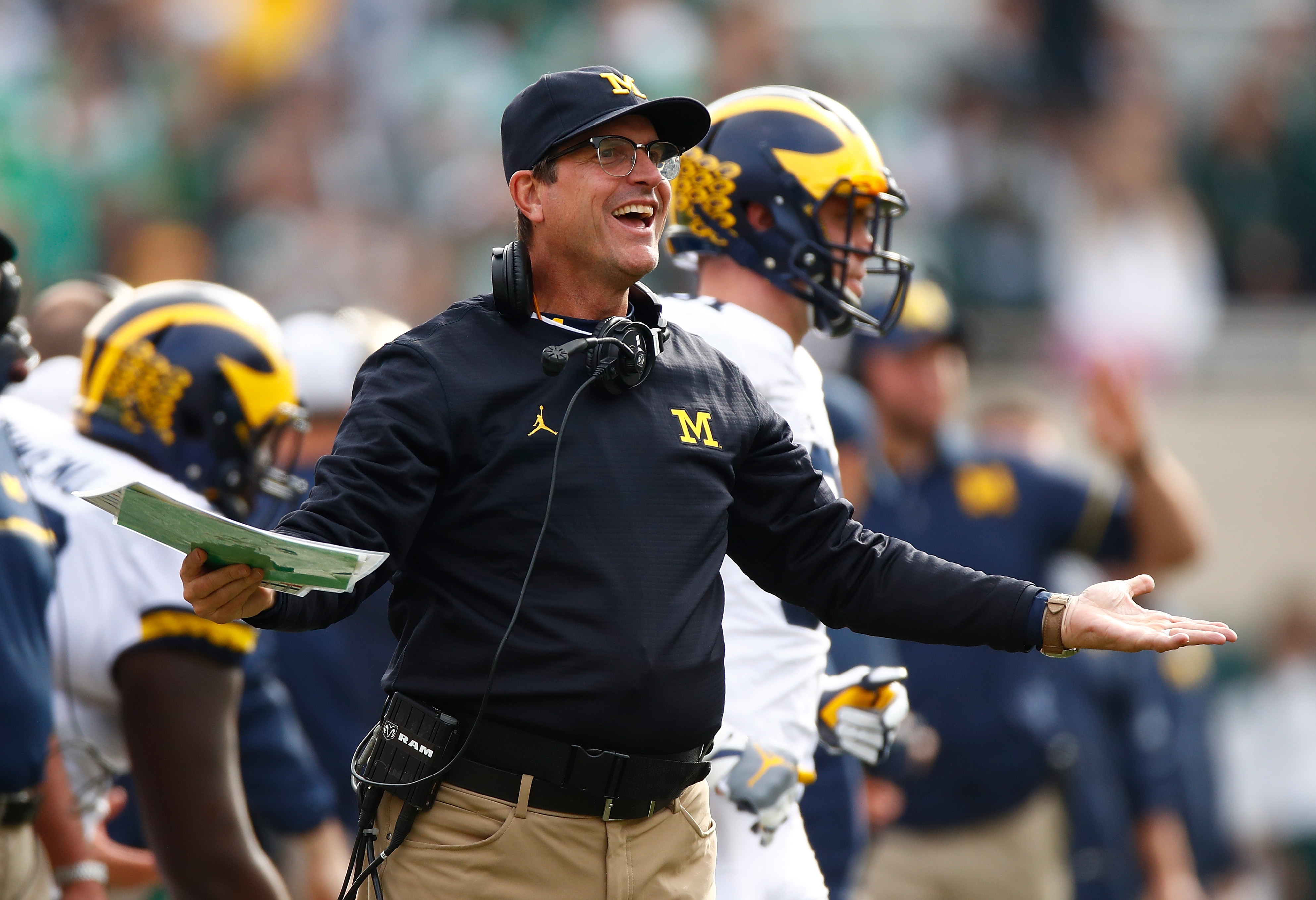 Harbaugh wears more than khakis? Throwback photo with NFL legends proves  he's got style - Maize n Brew