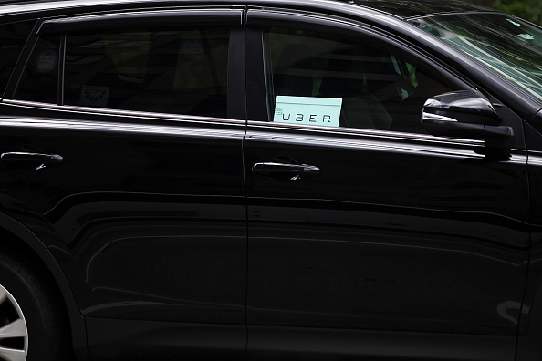 NEW YORK, NY - JULY 20:  An Uber vehicle is viewed in Manhattan on July 20, 2015 in New York City. New York's City Council has proposed two bills last month to limit the number of new for-hire vehicles, as well as to study the rapidly rising industry's impact on traffic. Uber has responded in an open letter arguing that its 6,000 Uber cars out during an average hour are a small part of the city's overall traffic. In cities across the globe Uber has upended the traditional taxi concept with many drivers and governments taking action against the California based company.  (Photo by Spencer Platt/Getty Images)