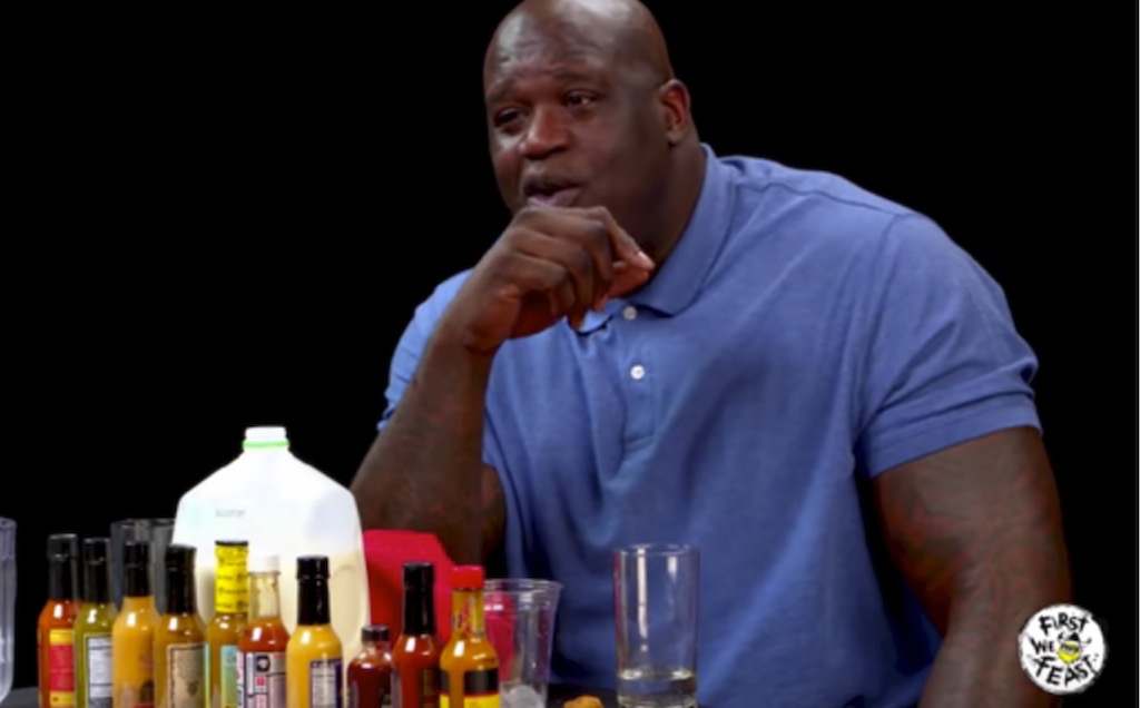 Hot Ones Shaq Tries to Not Make a Face While Eating Spicy Wings