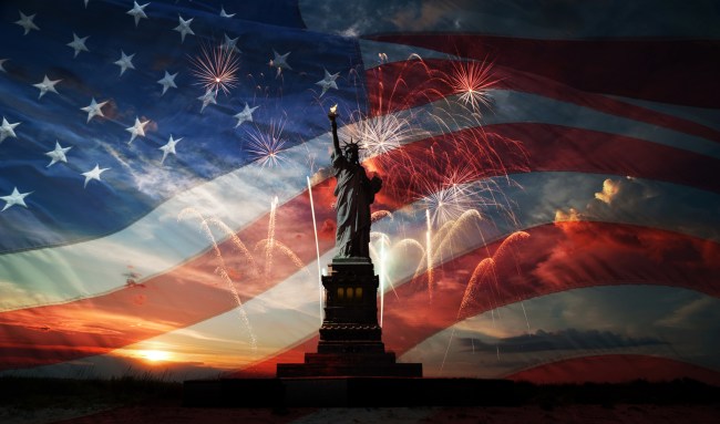 Statue of Liberty on the background of flag usa, sunrise and fireworks