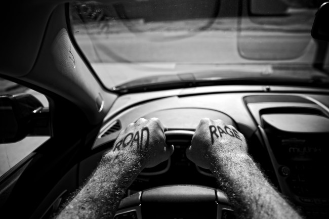 road rage hands gripping steering wheel in traffic