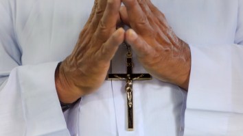 Priest Uses Squirt Gun To Shoot Holy Water At Parishioners During Drive-By Church Service And Instantly Becomes A Meme
