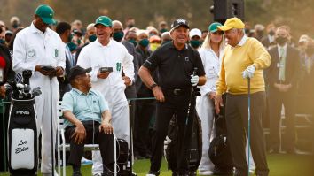 Gary Player’s Caddie-Son Stands Behind Lee Elder And Promotes Golf Balls During Masters’ Opening Tee Ceremony
