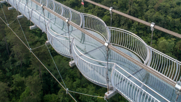 Terrifying Photo Shows A Tourist Holding On For Dear Life After A Glass Bridge 330 Feet Above The Ground Shattered In China