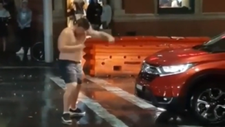 Shirtless Man Tries To Fight A Car In The Middle Of The Street In Front Of A KFC In The Pouring Rain