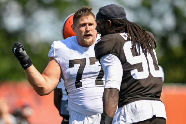 BEREA, OH - AUGUST 03: Offensive guard Wyatt Teller #77 of the Cleveland Browns jokes with defensive end Jadeveon Clowney #90 during Cleveland Browns Training Camp on August 3, 2021 in Berea, Ohio.