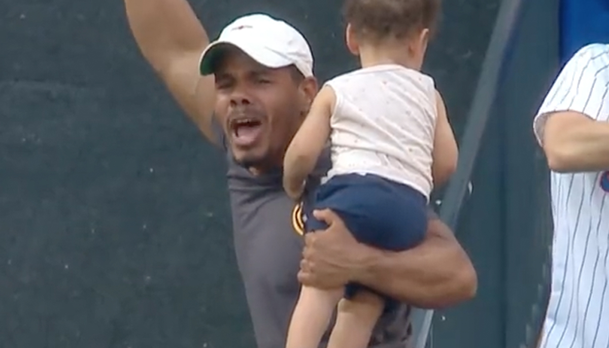 Fan makes incredible catch on foul ball while bottle feeding baby