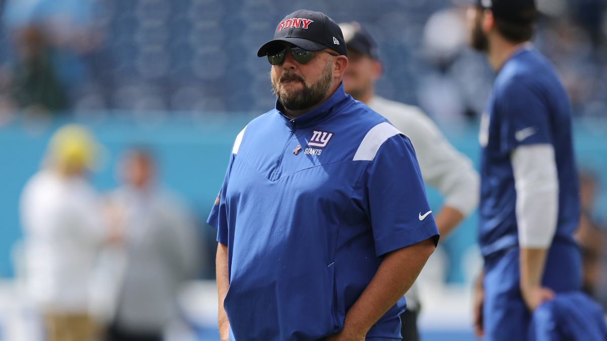 Giants fan gives Brian Daboll (on his shirt) a sip of beer 