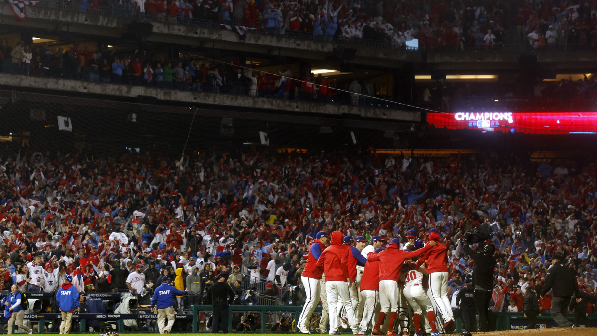 Phillies fans pose with 2022 NLCS trophy in Clearwater