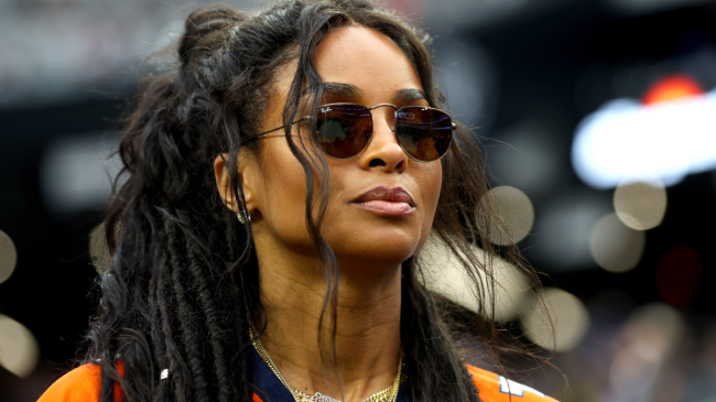 Ciara stands on the sidelines at a Broncos game.