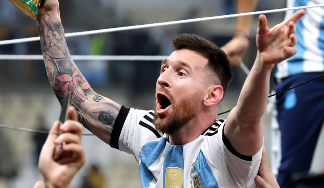 Lionel Messi of Argentina celebrates with World Cup trophy