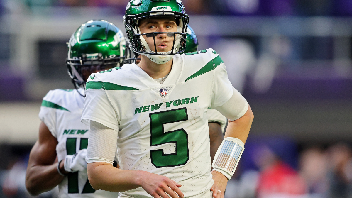 New York Jets quarterback Mike White (5) tries to avoid being taken down by  Buffalo Bills' Matt Milano, bottom, during the second half of an NFL  football game, Sunday, Nov. 14, 2021