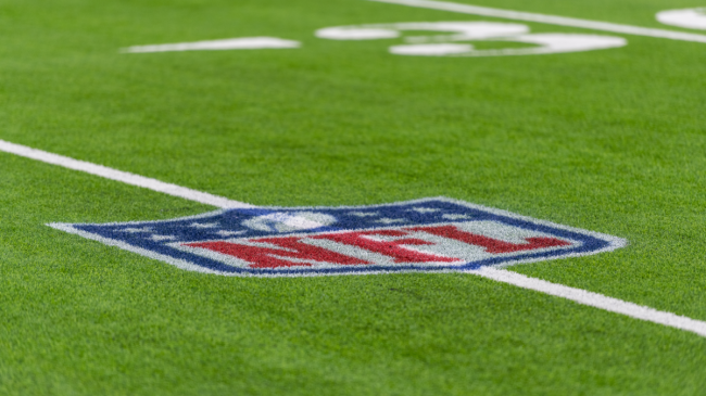 An NFL logo on the field.