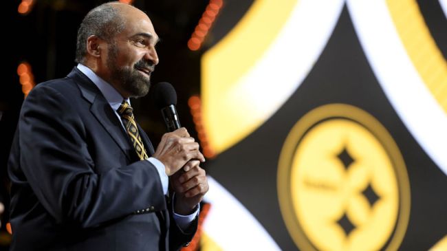 franco harris holding a mic at the nfl draft