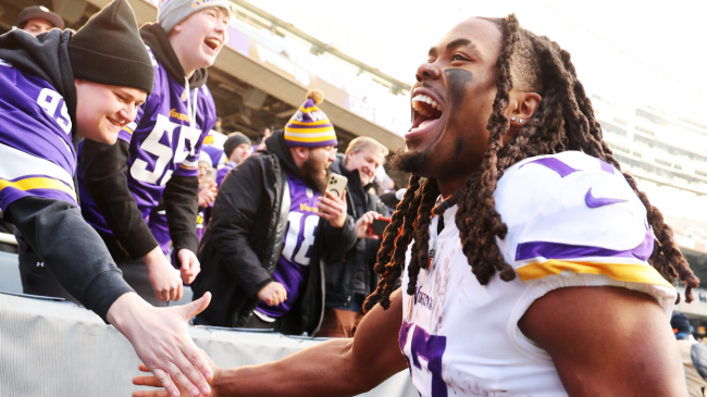 A Vikings player celebrates with fans.