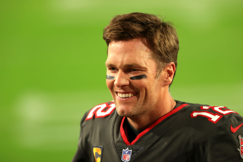 Tom Brady smiling on the field