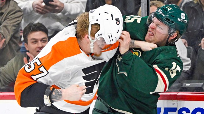 Wade Allison and Mason Shaw fight during a game between the Flyers and Wild