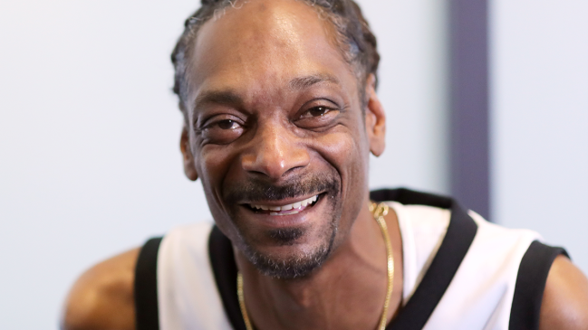Snoop Dogg wearing a basketball jersey