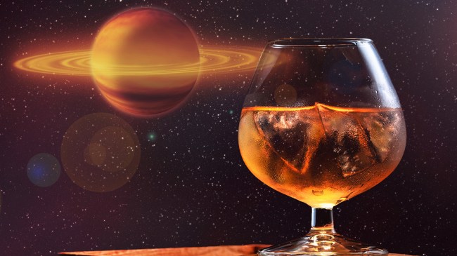 glass of whiskey in front of outer space background