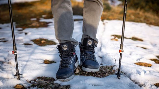 Lems Shoes Outlander Waterproof Boots in snow with walking poles