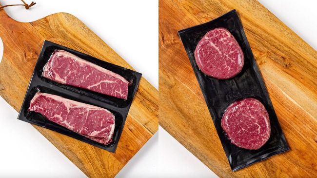 Raw steak from Butcherbox in the package on a wood cutting board