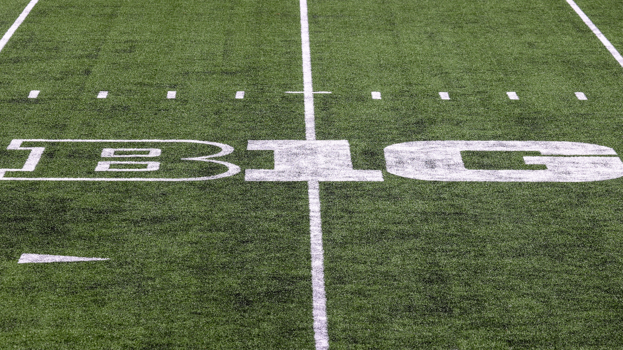 A Big Ten logo on the football field.
