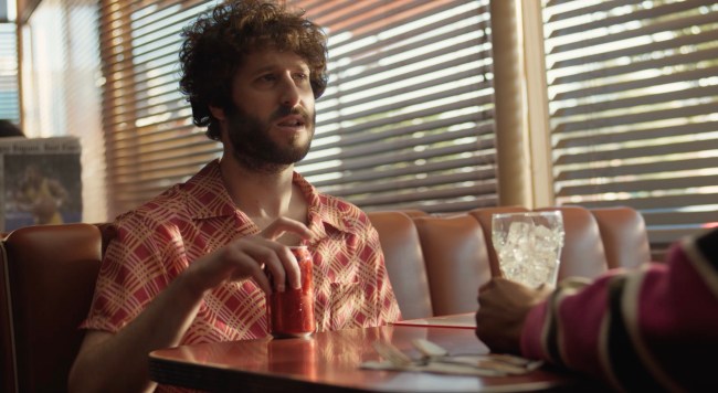 Lil Dicky pictured in a diner booth with a can of Coke Zero Sugar for a Coke Zero Sugar commercial