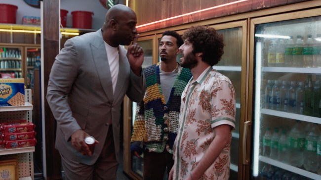 Lil Dicky, Travis Bennett, and Magic Johnson pictured in a store drink cooler aisle in a new Coke Zero Sugar commercial