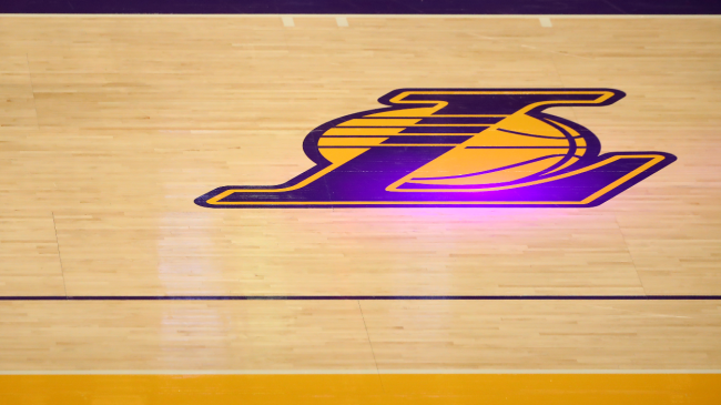 A Lakers logo on the court.