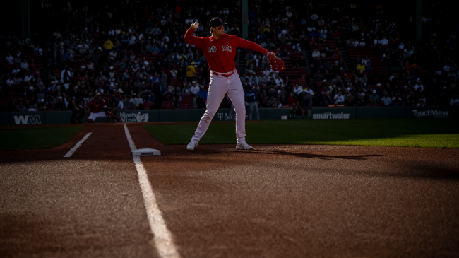 Triston Casas throws a baseball.