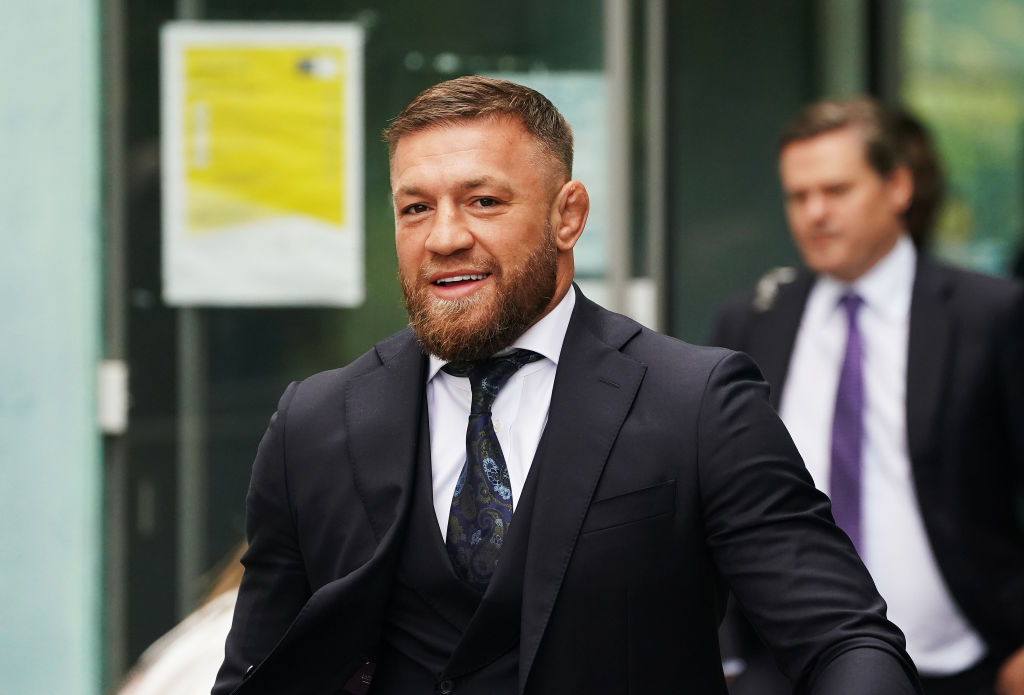 Conor McGregor smiling walking to courtroom