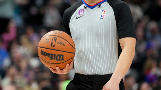 An NBA referee holds a basketball.