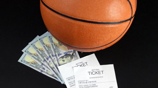 A basketball sits next to a betting slip.