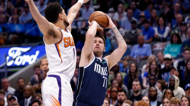 Luka Doncic shoots over Devin Booker.