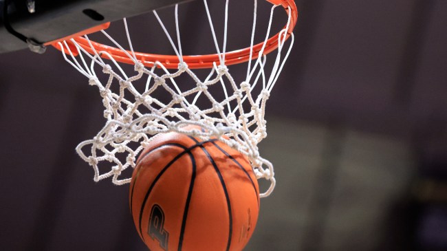 A basketball with a Purdue logo goes through the net.