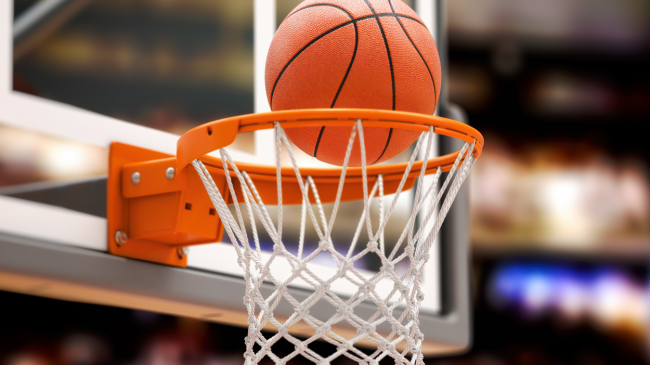 A basketball goes through the hoop.