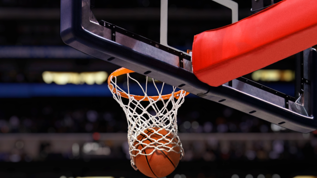 A basketball goes through the net.