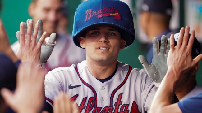 Austin Riley of the Atlanta Braves wears a big hat in the dugout