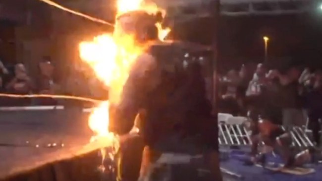 Pro wrestler MASADA lights himself on fire during a deathmatch