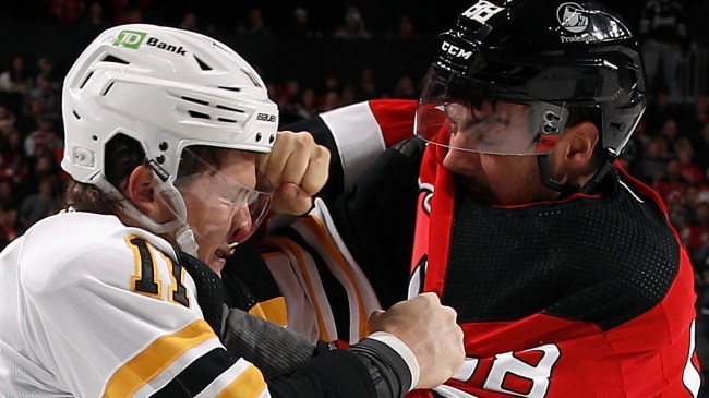 Trent Frederic and Kevin Bahl fighting during NHL game between the Bruins and Devils