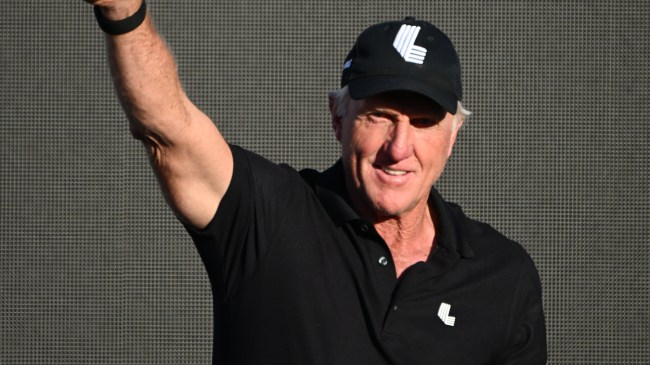 Greg Norman waves to the crowd at a LIV Golf event.