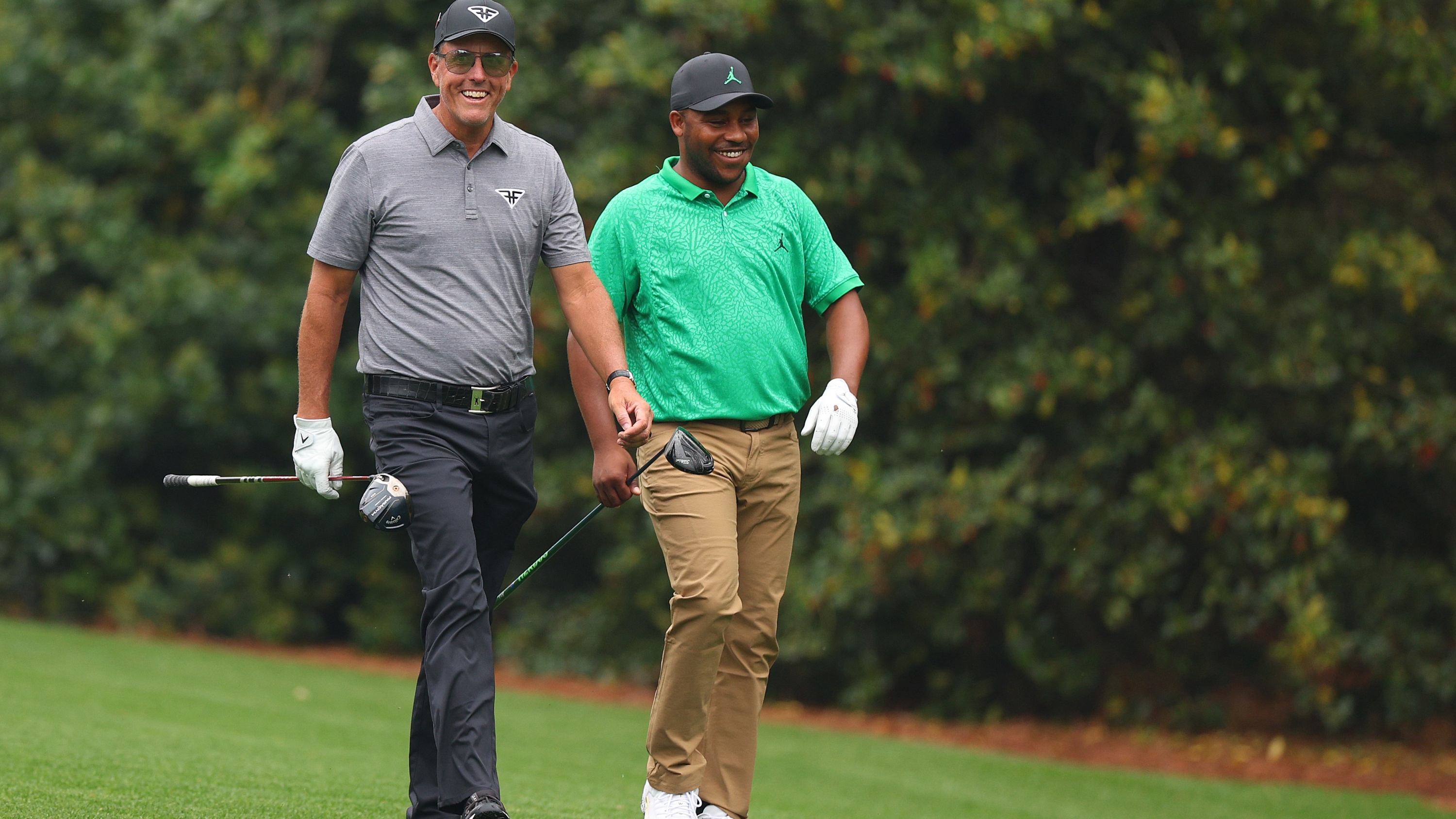 Harold Varner III and Phil Mickelson at The Masters