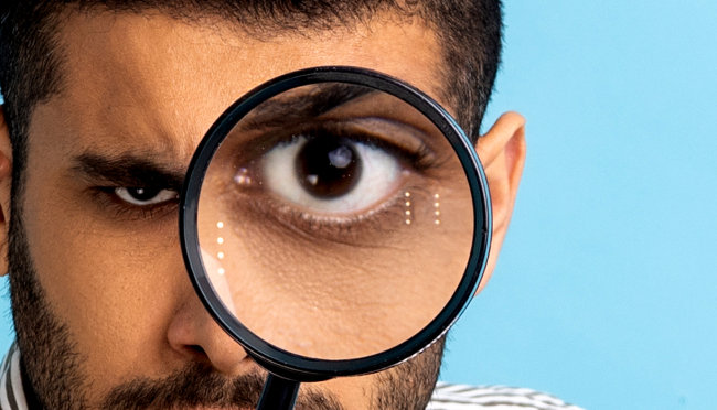 man looking magnifying glass real vs fake viral video