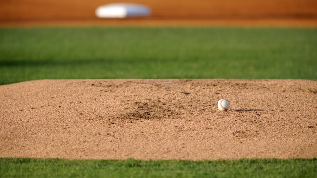A baseball rests on the pitcher's mound.